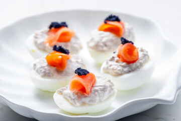 Wall Mural - boiled eggs filled with tuna fish spread and smoked salmon and  black caviar on the top