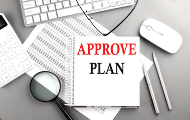 Poster - APPROVE PLAN text on notepad on chart with keyboard and calculator on grey background