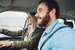 Couple in car, transport and travel on road trip together, happy on adventure and spending quality time. Young, man and woman drive, love and romance, smile while bonding on the road.