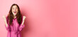 © Mix and Match Studio - Beautiful smiling woman scream with happy and excited face, saying yes, making fist pump, winning and feeling like champion, triumphing, standing over pink background