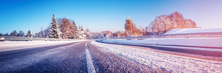 Wall Mural - Panoramic view of the wide snowy road in winter