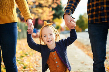 Wall Mural - Adorable two years old girl enjoying nice and sunny autumn day outdoors