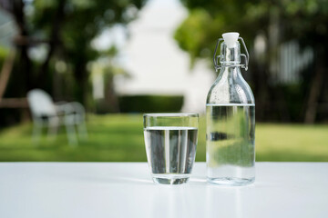 Wall Mural - A glass of clean drinking water and a water bottle.