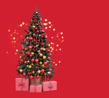 Christmas Tree In A Basket With Gifts Boxes Against Red Background