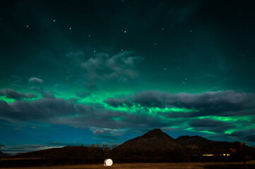 aurora borealis from clouds - hofn, iceland