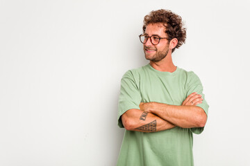 Wall Mural - Young caucasian curly hair man isolated on white background smiling confident with crossed arms.