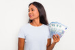 © Asier - Young indian woman holding a banknotes isolated on white background looks aside smiling, cheerful and pleasant.
