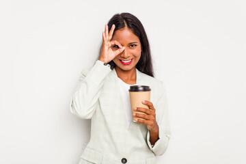 Wall Mural - Young business Indian woman holding takeaway coffee isolated on white background excited keeping ok gesture on eye.