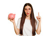 Young caucasian woman holding a piggy bank isolated having an idea, inspiration concept.