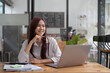 © wichayada - Asian Business woman using calculator and laptop for doing math finance on an office desk, tax, report, accounting, statistics, and analytical research concept