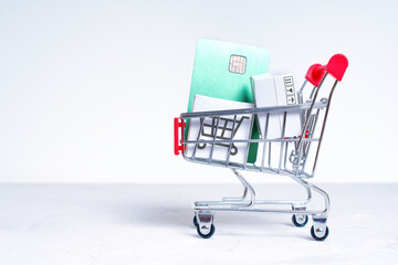 Shopping trolley with small boxes and credit card