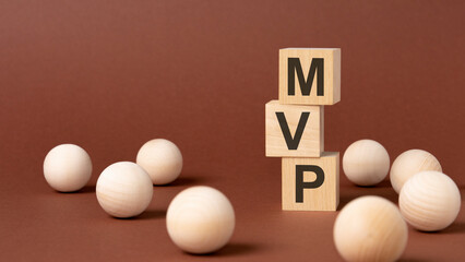 Sticker - wooden blocks with text MVP on yellow paper, business concept. mvp - short for minimum viable product