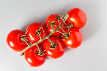 Wall Mural - cherry tomatoes on the stem, cherry tomatoes on a white background