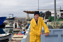 Portrait Of A Fisherman Standing  In The Port