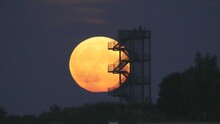 Onlookers watching the moon from the observation tower in Syke, Germany