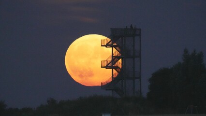 Wall Mural - Onlookers watching the moon from the observation tower in Syke, Germany