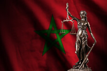 Morocco Flag With Statue Of Lady Justice And Judicial Scales In Dark Room. Concept Of Judgement And Punishment