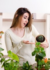 Wall Mural - Young female gardener with plants indoors