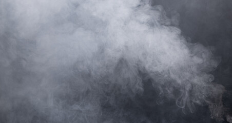 Fototapete - Dense Fluffy Puffs of White Smoke and Fog on black Background, Abstract Smoke Clouds, Movement Blurred out of focus. Smoking blows from machine dry ice fly fluttering in Air, effect texture
