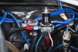 Close-up of car fuel pressure regulators in the engine bay.