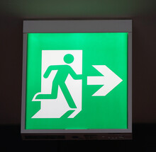 Glowing Green Emergency Exit Signs Indoors In Japanese Buildings