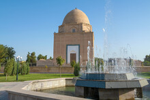 City Fountain Against The Background Of The Medieval Rukhabod Mausoleum On A Sunny Day. Samarkand, Uzbekistan