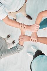Poster - Hands, collaboration and unity with a business team holding arms in an office together from above. Trust, support and teamwork with a man and woman employee group standing in solidarity or faith