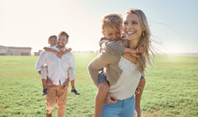 Family, Kids And Piggy Back At Park, Nature Or Outdoors On Vacation, Holiday Or Summer Trip. Love, Support And Caring Parents, Man And Woman Bonding With Boys, Carrying And Enjoying Fun Time Together