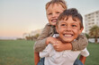 © Beaunitta Van Wyk/peopleimages.com - Happy, smile and portrait of brothers with piggyback ride playing in a park together on vacation. Happiness, excited and children bonding in nature while on a summer holiday adventure in Australia.