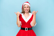 Young Blonde Woman Dressed As Mama Claus Isolated On Blue Background With Thumbs Up Gesture And Smiling