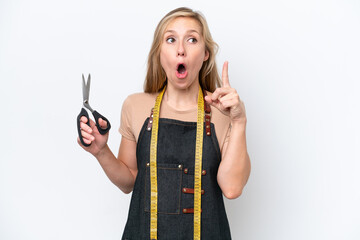 Wall Mural - Young blonde seamstress woman isolated on white background thinking an idea pointing the finger up