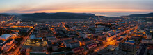 Beautiful Morning Panorama Of The City. Top View Of The Streets And Buildings. In The Distance The Sea And Hills. Dawn. Aerial View Of The City Of Magadan. Magadan Region, Siberia, Russian Far East.