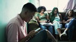 © Marco - One hispanic man looking at cellphone device in foreground. Three female black friends in background using phones