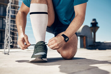 Canvas Print - Soccer, man and tie shoe for training, exercise and workout on concrete court before sports game and match. Football, fitness and athlete prepare shoes for cardio sport performance on outdoor court