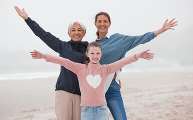 Poster - Family, love and beach with a girl, mother and grandmother on the sand by the sea or ocean during a vacation together. Travel, love and nature with a senior woman, daughter and grandchild on holiday