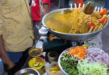 Indian Street Food Seller Selling Food At Roadside Food Stall