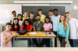 © Xavier Lorenzo - Large group portrait of millennial diverse students with male teacher smiling at camera standing together in classroom - High school teenage people posing for a group photo - Education concept