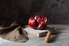 Fresh Rape Pomegranate On A Small Cutting Board