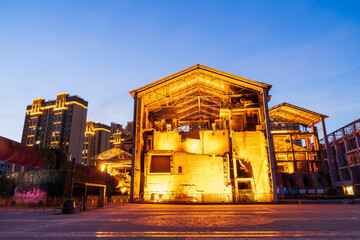 Wall Mural - Factory buildings and industrial equipment in the evening