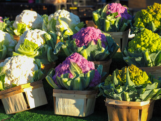 Display of multicolored cauliflowers in baskets