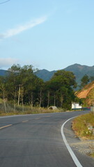 The beautiful countryside view with the road and mountains as background