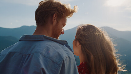 Smiling couple look mountains landscape view. Happy lovers enjoy hike outdoors.