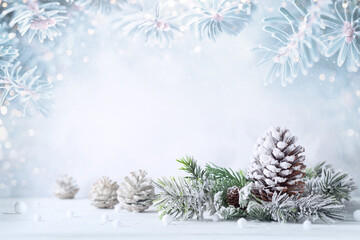 Wall Mural - christmas still life with snowy pine cones, baubles and fir branches on light background. winter or 
