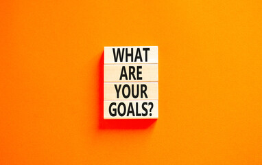 Wall Mural - What are your goals symbol. Concept words What are your goals on wooden blocks. Beautiful orange table orange background. Business, psychological what are your goals concept. Copy space.