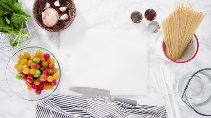 Poster - Flat lay. Step by step. Cutting vegetables on a white cutting board to make a one-pot pasta recipe.