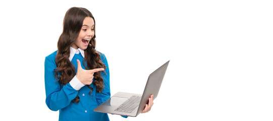 Sticker - surprised child long curly hair pointing finger on laptop isolated on white, school blog. School girl portrait with laptop, horizontal poster. Banner header with copy space.