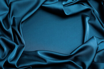 Crumpled dark blue silk fabric as background, closeup view. Space for text