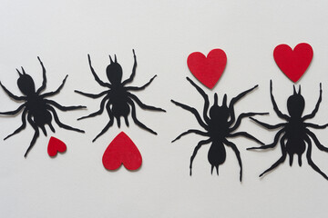 Wall Mural - black paper silhouettes of spiders and wooden hearts painted red