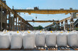 Big bags with calcium carbonate in yard of production plant