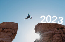 2023 New Year Concept, Silhouette A Man Jumping To 2023
